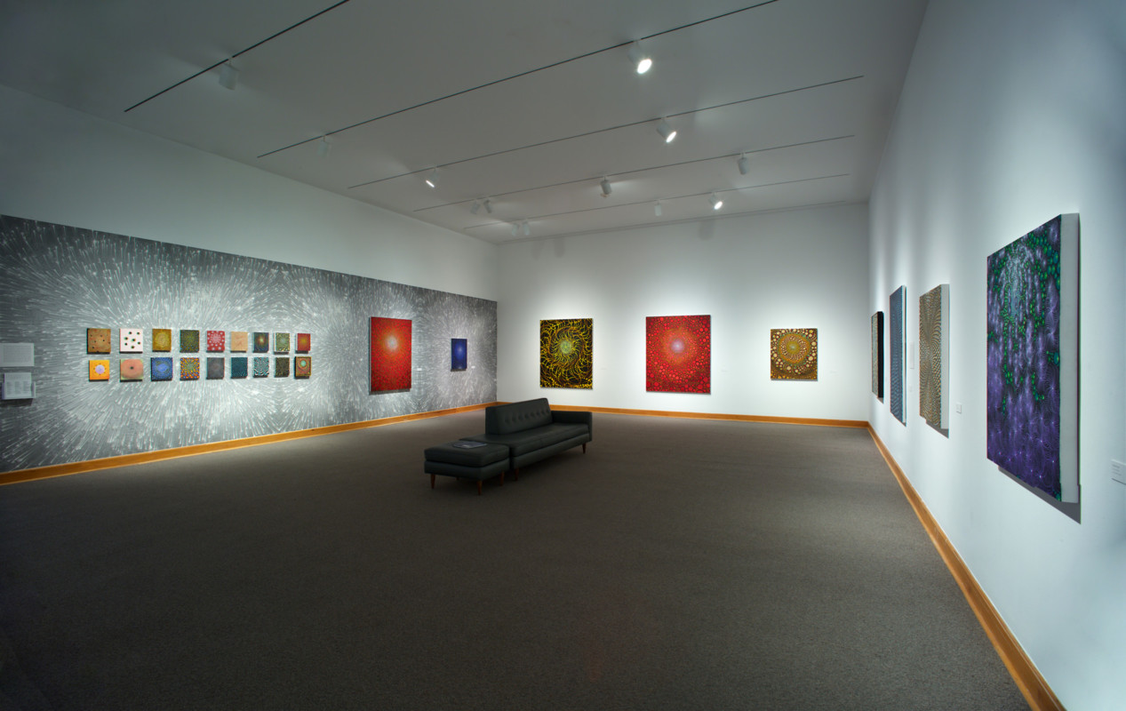 A large gallery space at the Williams College Museum of Art with colorful prints displayed on three walls.